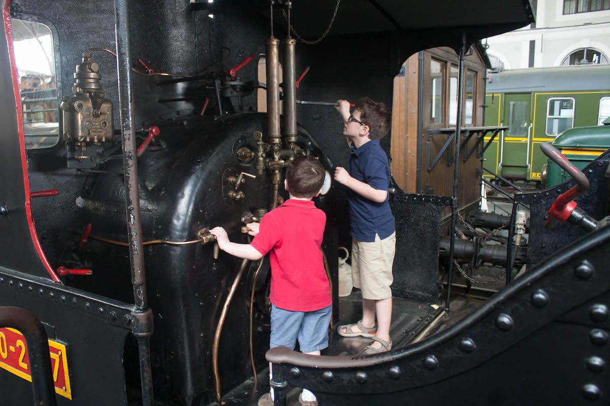 Dos jóvenes explorando un viejo vagón de tren negro